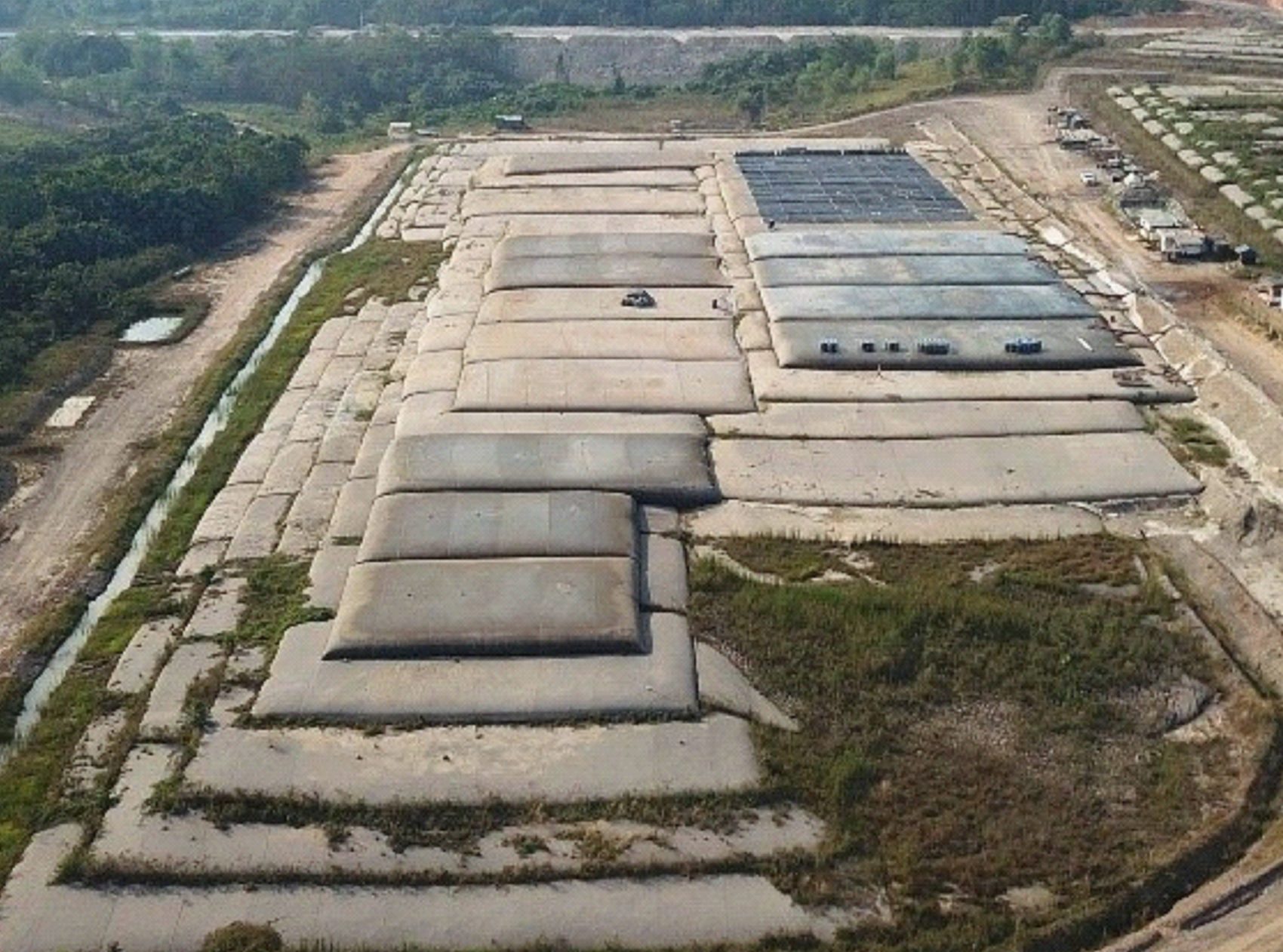 Rows of geotextile tubes dry-stacking tailings on a lined and graded pad